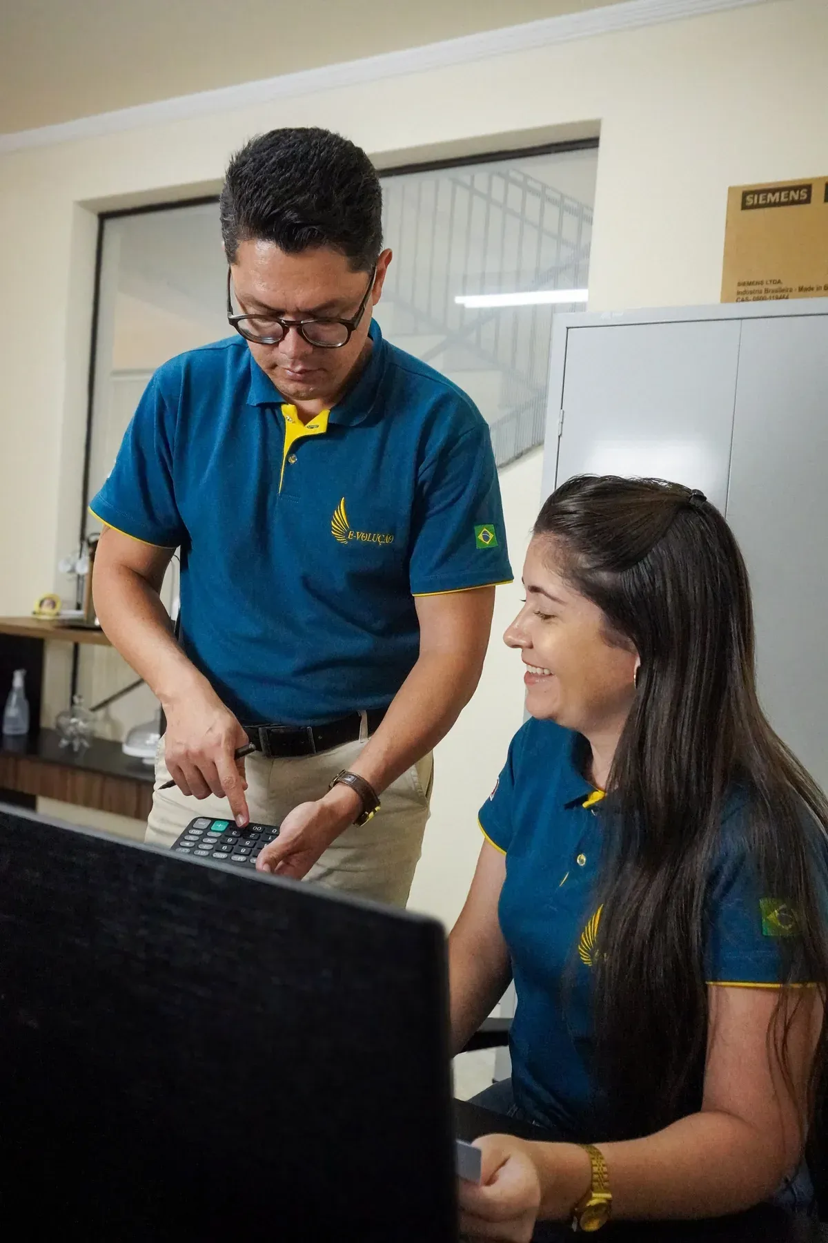 Francklin e Daiana Pádua conversando em frente ao computador